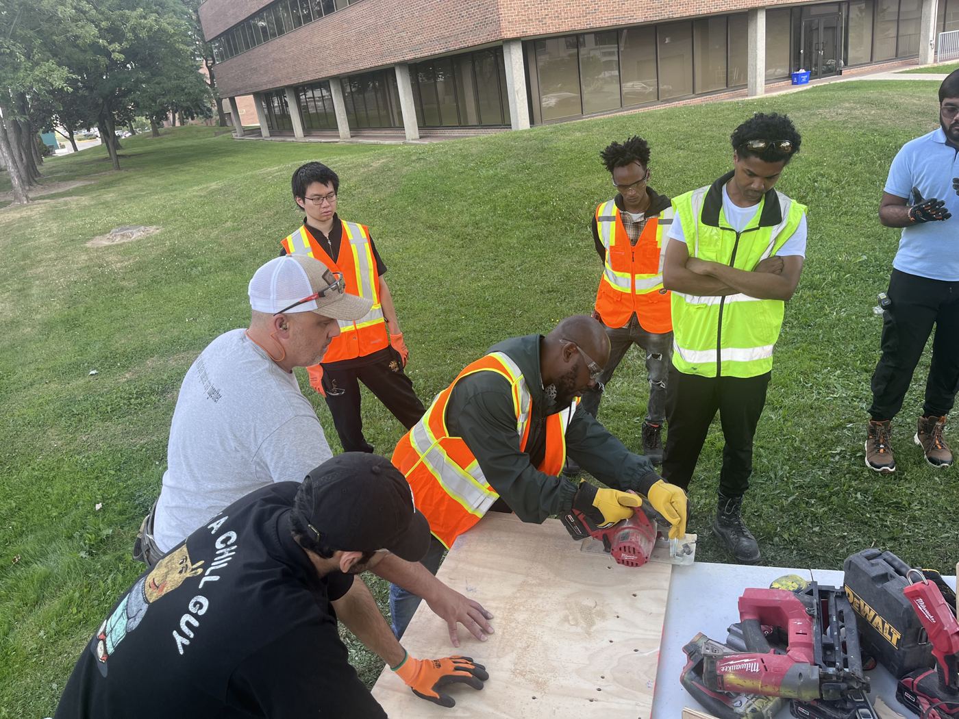 Participant making a guided cut with a circular saw